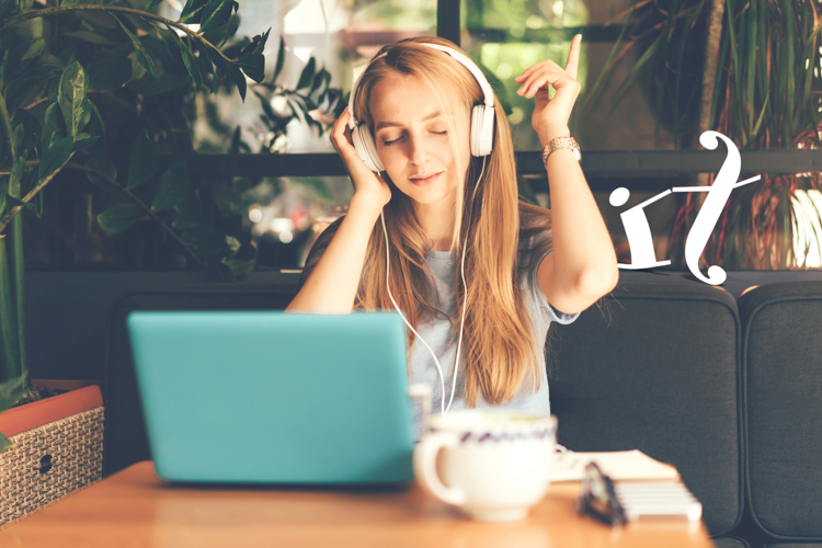 a girl working on her laptop and listening to music