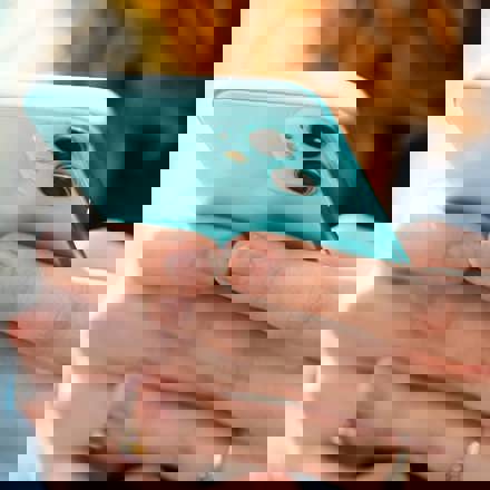 Instant Finance key information. Woman holding a mobile phone. loans nz