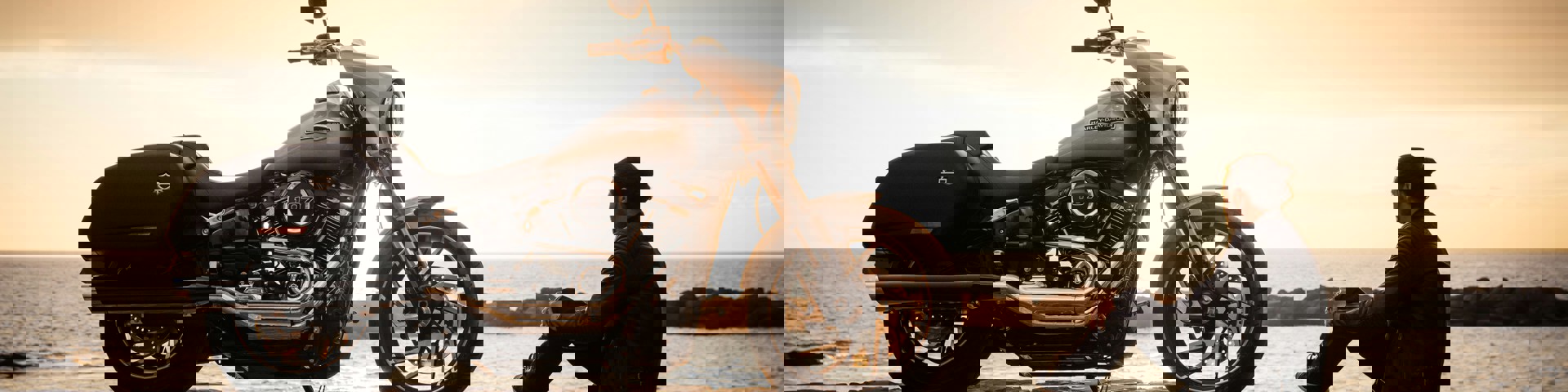 Man at sunset with his motorbike thinking about motorbike finance