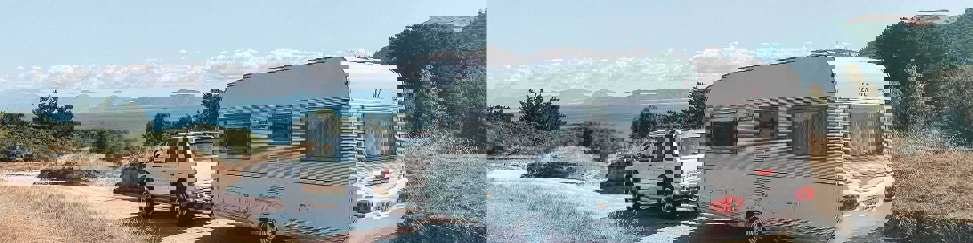 SUV towing a caravan on a gravel road, caravan finance, motorhome finance