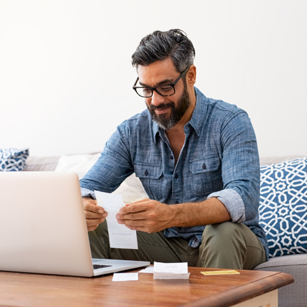 Man on laptop computer looking at his financial health
