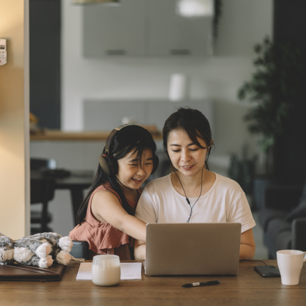 Woman on a computer with her daughter applying for personal student loans